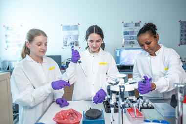 Three of the 2025 ASSIP Interns working in the lab.